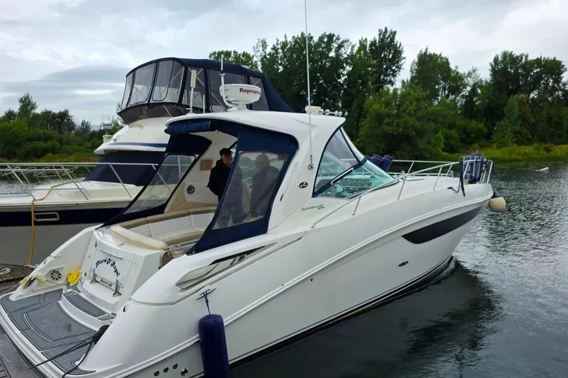  Yacht Photos Pics 2013 Sea Ray 370 Sundancer yacht docked on a calm river with lush greenery.