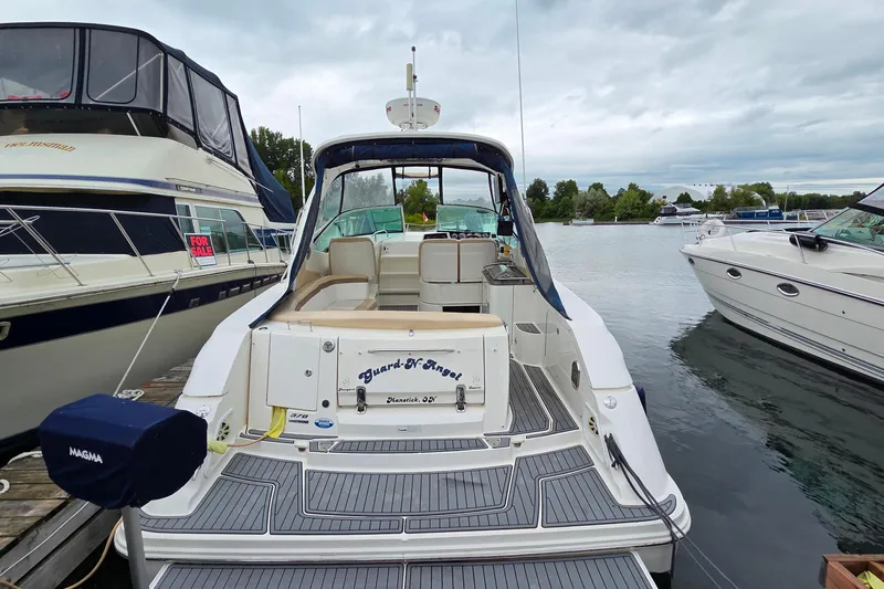  Yacht Photos Pics 2013 Sea Ray 370 Sundancer docked, showcasing spacious deck and elegant design.