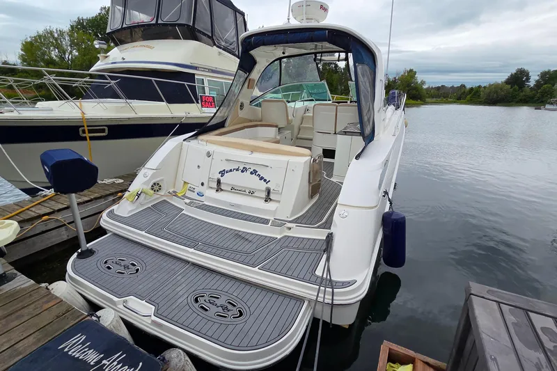  Yacht Photos Pics 2013 Sea Ray 370 Sundancer docked, showcasing spacious deck and elegant design.