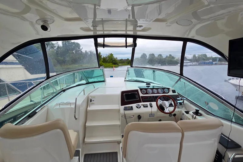  Yacht Photos Pics Interior view of 2013 Sea Ray 370 Sundancer yacht cockpit with steering wheel and controls.