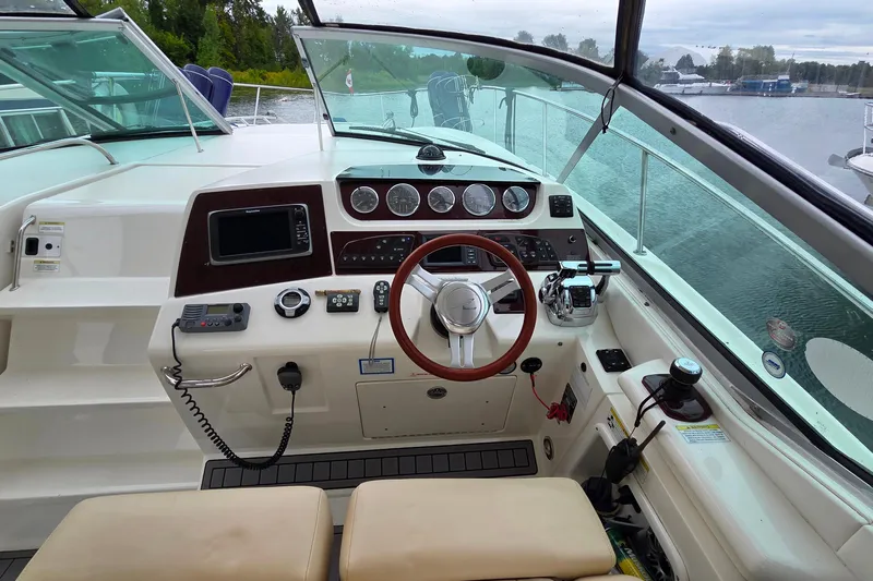  Yacht Photos Pics Cockpit of 2013 Sea Ray 370 Sundancer with steering wheel and control panel.