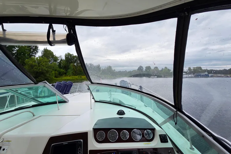  Yacht Photos Pics Interior view of 2013 Sea Ray 370 Sundancer boat navigating a calm waterway.