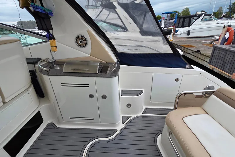  Yacht Photos Pics 2013 Sea Ray 370 Sundancer boat interior with kitchenette and seating area at a marina.