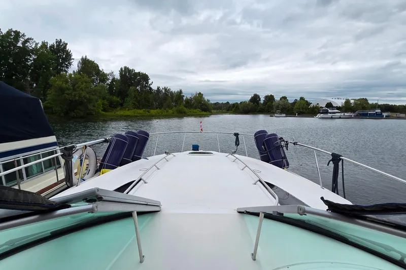  Yacht Photos Pics 2013 Sea Ray 370 Sundancer yacht on a serene lake with lush greenery.