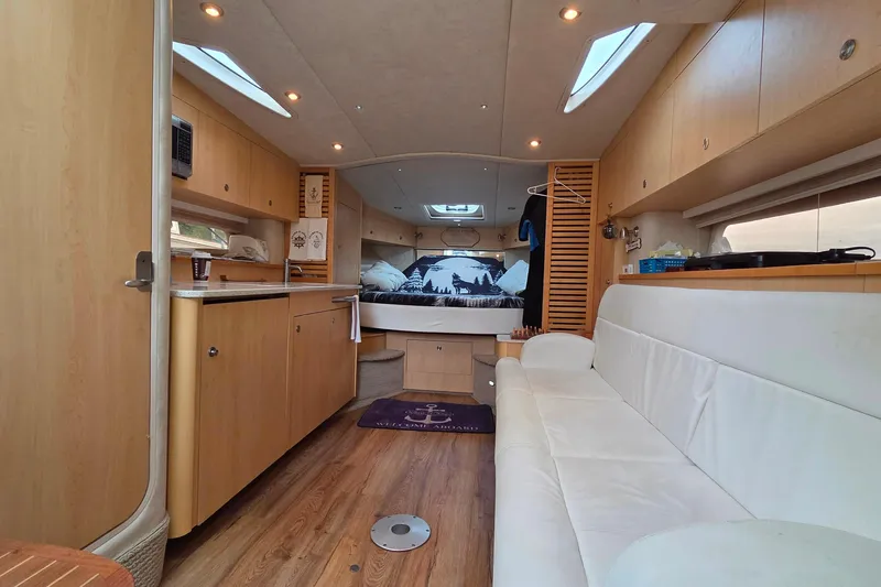  Yacht Photos Pics Interior of 2013 Sea Ray 370 Sundancer yacht with modern kitchen and cozy seating area.