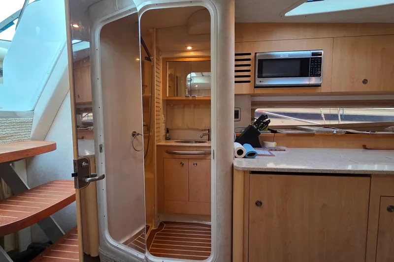  Yacht Photos Pics Interior of 2013 Sea Ray 370 Sundancer yacht with kitchenette and bathroom.