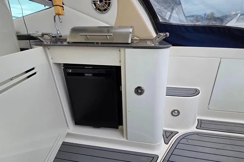  Yacht Photos Pics Outdoor kitchenette on 2013 Sea Ray 370 Sundancer yacht with grill and mini fridge.