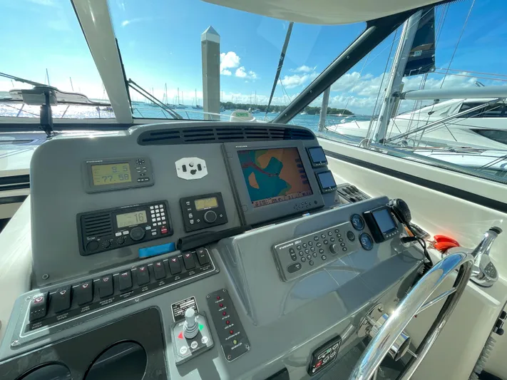 Family Bonds Yacht Photos Pics Helm of 2005 Tiara Yachts 4400 Sovran with navigation equipment and controls.