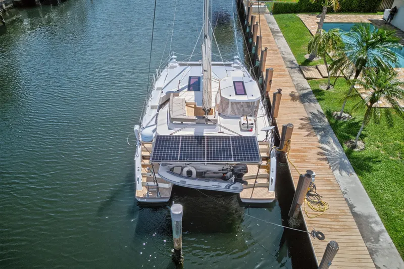 Ten-seven Freedom Yacht Photos Pics 2023 Leopard 42 catamaran docked, featuring solar panels and a scenic waterfront view.