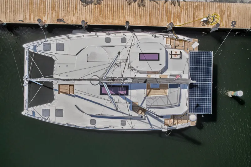 Ten-seven Freedom Yacht Photos Pics Overhead view of 2023 Leopard 42 catamaran docked, featuring solar panels and spacious deck.
