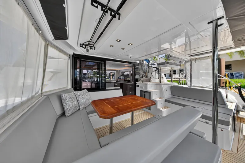 Ten-seven Freedom Yacht Photos Pics Luxurious 2023 Leopard 42 yacht interior with modern seating and wooden table.