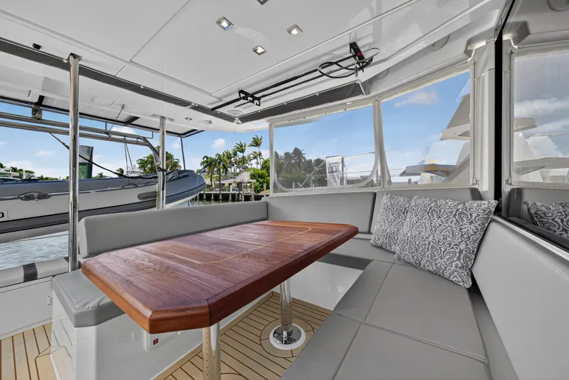 Ten-seven Freedom Yacht Photos Pics Luxurious 2023 Leopard 42 yacht interior with elegant seating and wooden table.