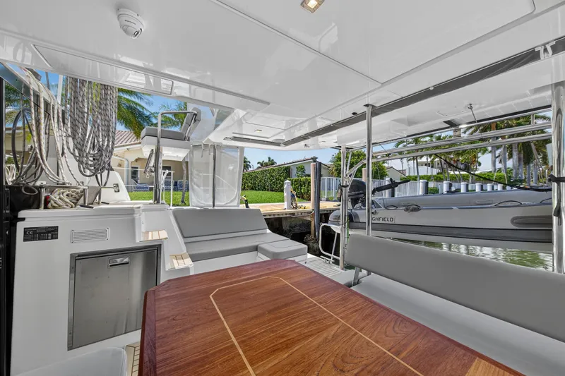 Ten-seven Freedom Yacht Photos Pics Luxurious 2023 Leopard 42 yacht interior with sleek seating and polished wood table.