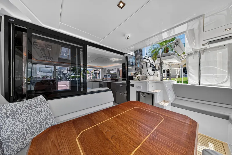 Ten-seven Freedom Yacht Photos Pics Luxurious interior of 2023 Leopard 42 yacht with modern design and wooden table.
