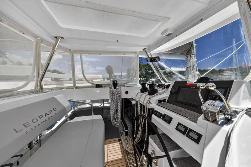 Ten-seven Freedom Yacht Photos Pics 2023 Leopard 42 catamaran cockpit with modern navigation equipment and sleek design.
