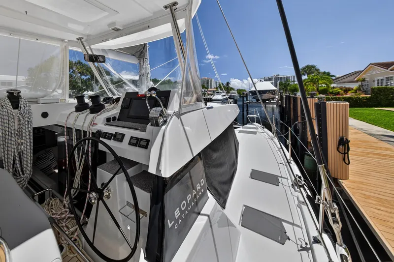 Ten-seven Freedom Yacht Photos Pics 2023 Leopard 42 catamaran docked, showcasing sleek design and modern navigation equipment.