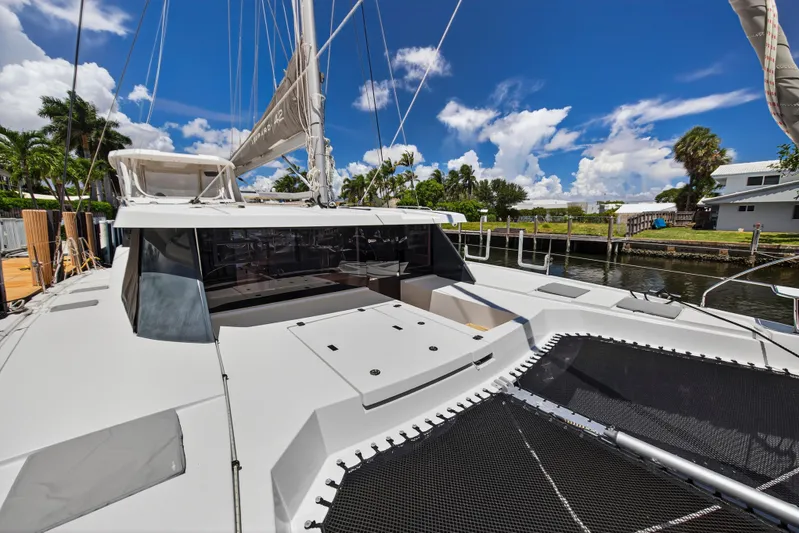 Ten-seven Freedom Yacht Photos Pics 2023 Leopard 42 catamaran docked, featuring sleek design and spacious deck under a clear blue sky.