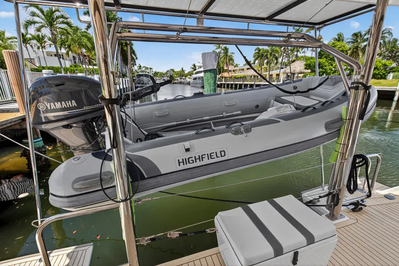 Ten-seven Freedom Yacht Photos Pics Inflatable boat with Yamaha motor on Leopard 42 yacht, docked in a sunny marina, 2023 model.