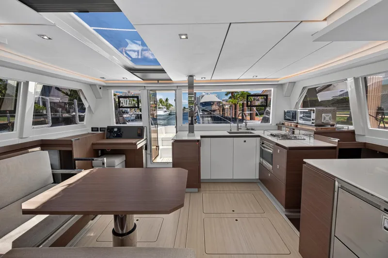 Ten-seven Freedom Yacht Photos Pics Modern interior of 2023 Leopard 42 yacht with sleek kitchen and dining area.