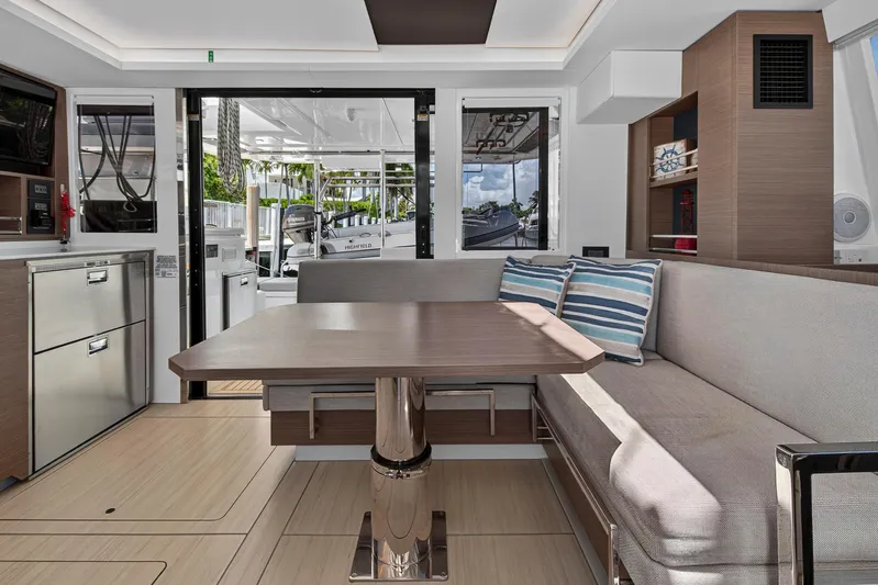 Ten-seven Freedom Yacht Photos Pics Luxurious interior of 2023 Leopard 42 yacht with modern dining area and stylish decor.