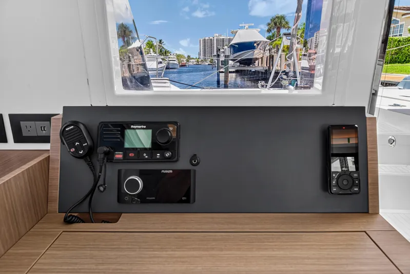 Ten-seven Freedom Yacht Photos Pics Control panel of 2023 Leopard 42 yacht with marina view through window.