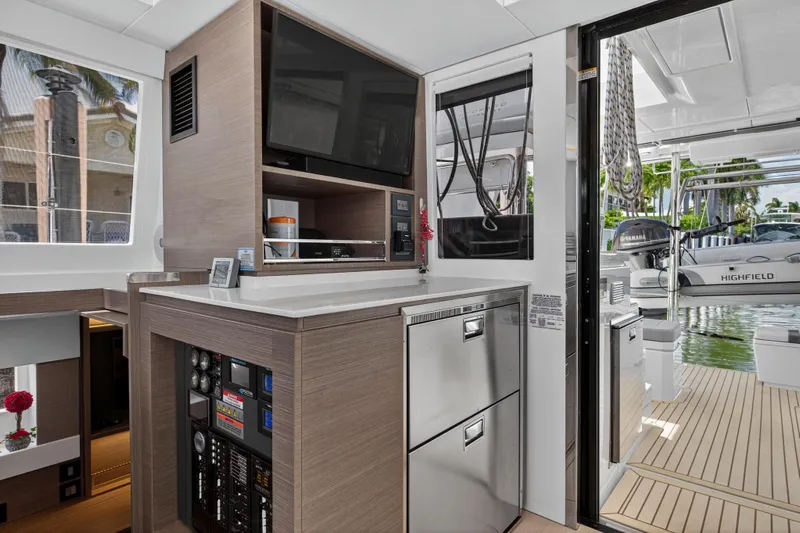 Ten-seven Freedom Yacht Photos Pics Modern interior of 2023 Leopard 42 yacht with sleek kitchen and outdoor view.