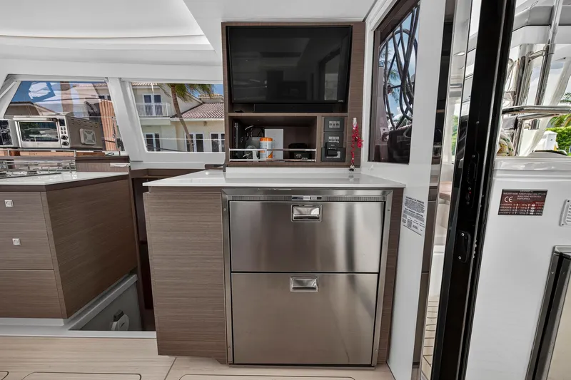 Ten-seven Freedom Yacht Photos Pics Modern kitchen area on 2023 Leopard 42 yacht with stainless steel appliances and sleek cabinetry.