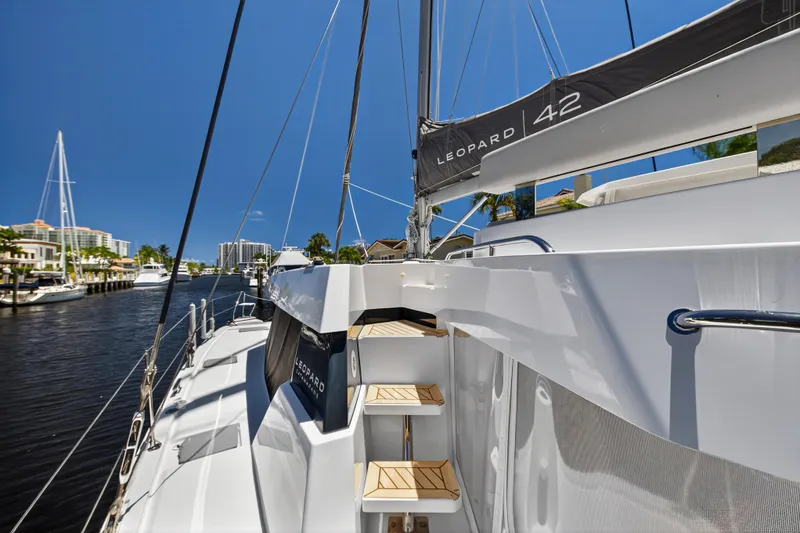 Ten-seven Freedom Yacht Photos Pics 2023 Leopard 42 catamaran docked in a sunny marina, showcasing sleek design and modern features.
