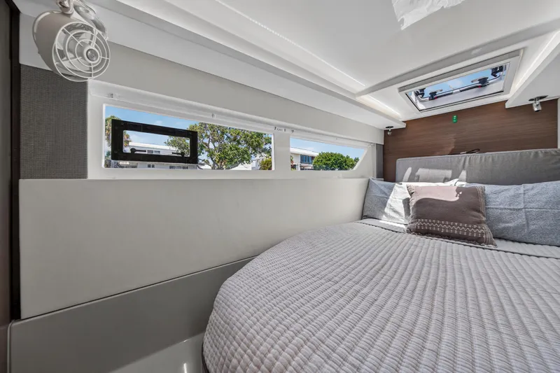 Ten-seven Freedom Yacht Photos Pics Luxurious interior cabin of 2023 Leopard 42 yacht with cozy bedding and scenic windows.