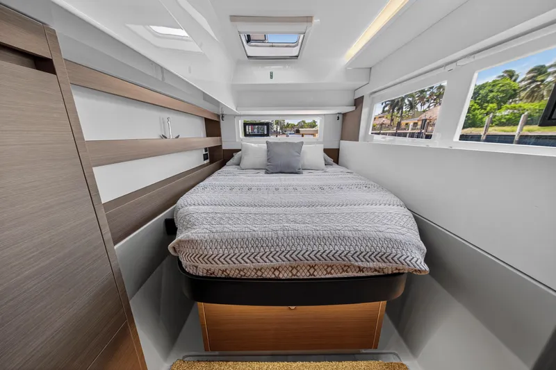 Ten-seven Freedom Yacht Photos Pics Luxurious bedroom interior of 2023 Leopard 42 yacht with modern design and large windows.