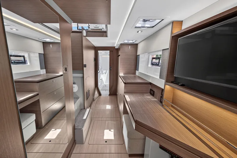 Ten-seven Freedom Yacht Photos Pics Modern interior of 2023 Leopard 42 yacht with sleek wood finishes and built-in TV.