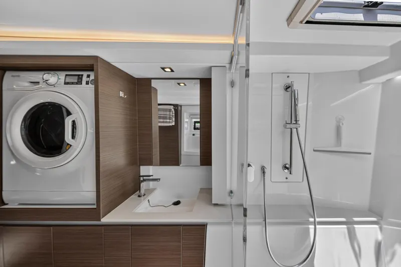 Ten-seven Freedom Yacht Photos Pics Modern bathroom in 2023 Leopard 42 yacht with washer, sink, and shower.