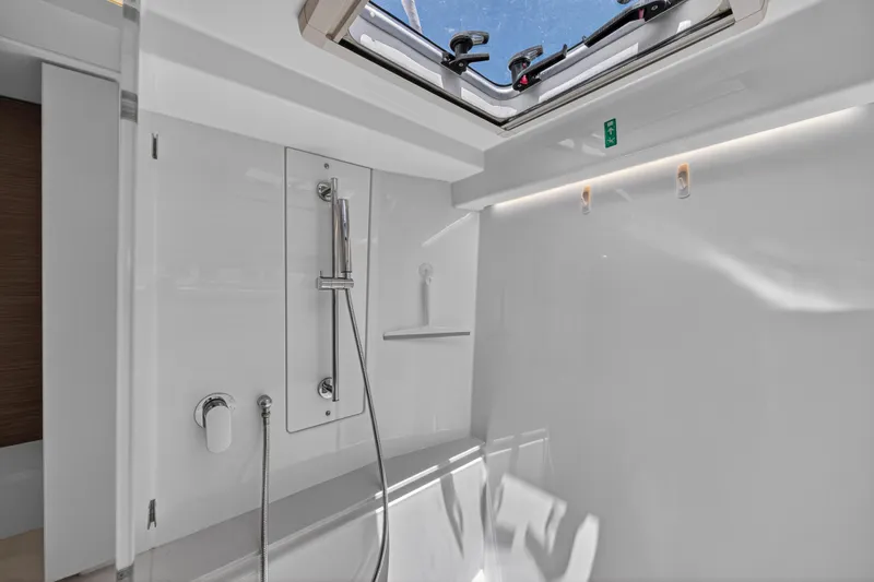 Ten-seven Freedom Yacht Photos Pics Modern bathroom interior on 2023 Leopard 42 yacht with skylight and sleek shower design.