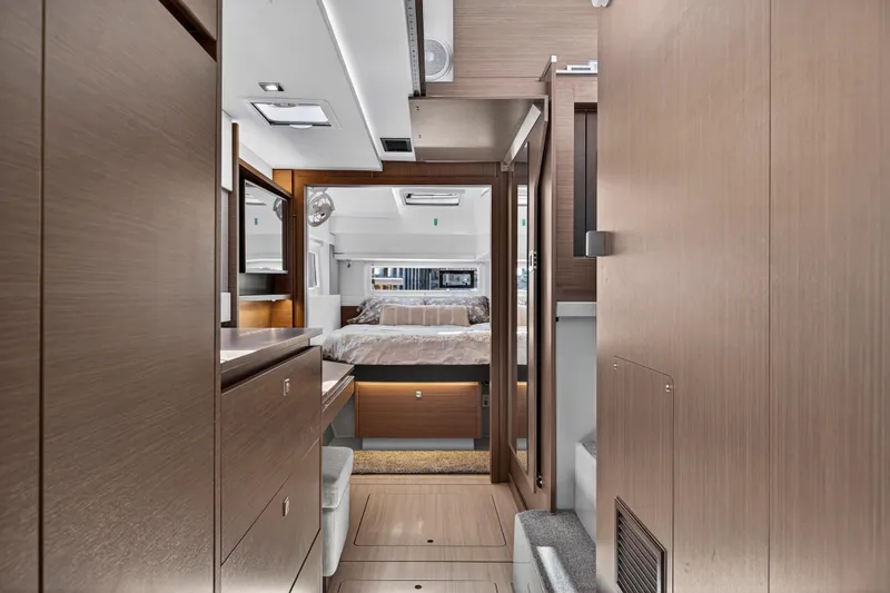 Ten-seven Freedom Yacht Photos Pics Luxurious interior of 2023 Leopard 42 yacht featuring modern wood finishes and cozy bedroom.