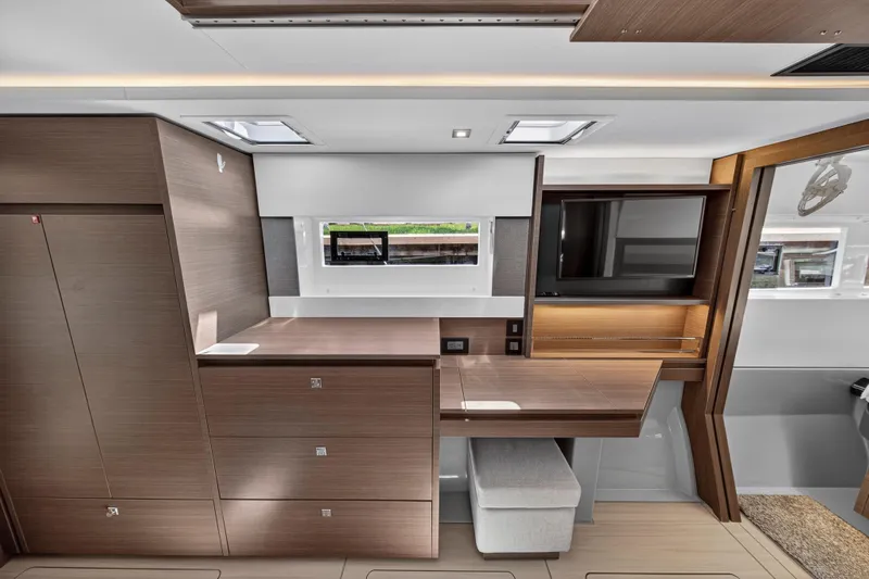 Ten-seven Freedom Yacht Photos Pics Modern interior of 2023 Leopard 42 yacht with sleek wood finish and built-in TV.
