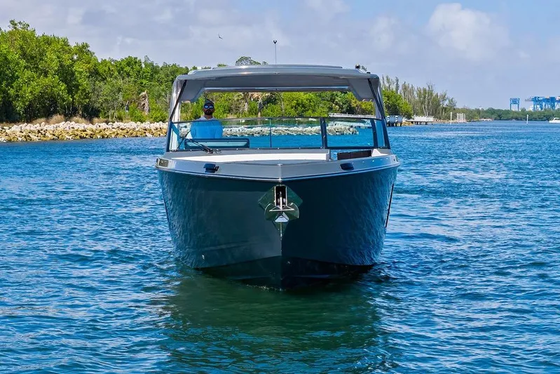  Yacht Photos Pics 2022 Aviara AV40 OB boat cruising on a sunny day, surrounded by lush greenery.