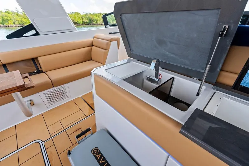  Yacht Photos Pics 2022 Aviara AV40 OB boat interior with tan seating and built-in sink.