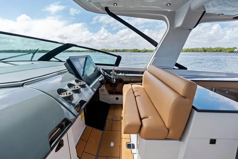  Yacht Photos Pics 2022 Aviara AV40 OB boat interior with modern dashboard and tan seating, overlooking water.