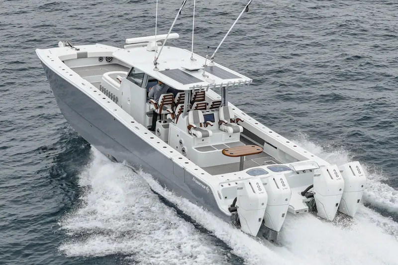  Yacht Photos Pics 2024 Freeman 47 boat cruising on open water with multiple outboard engines.