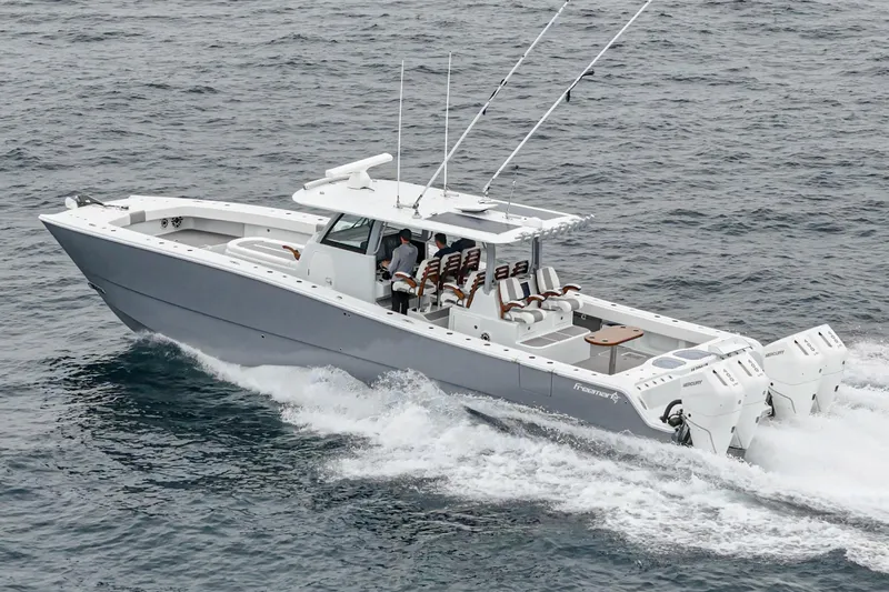  Yacht Photos Pics 2024 Freeman 47 boat cruising on open water, showcasing sleek design and powerful engines.