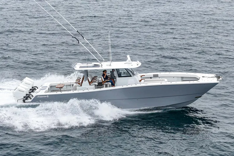  Yacht Photos Pics 2024 Freeman 47 boat cruising on open water, showcasing sleek design and powerful engines.