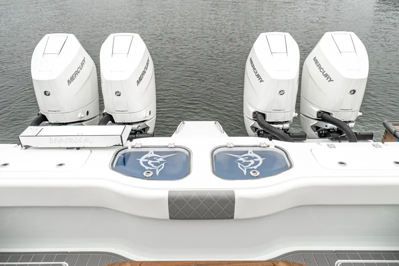  Yacht Photos Pics 2024 Freeman 47 boat with four Mercury engines on a calm water surface.