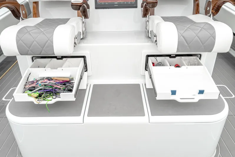  Yacht Photos Pics 2024 Freeman 47 boat interior with open tackle storage drawers and cushioned seats.