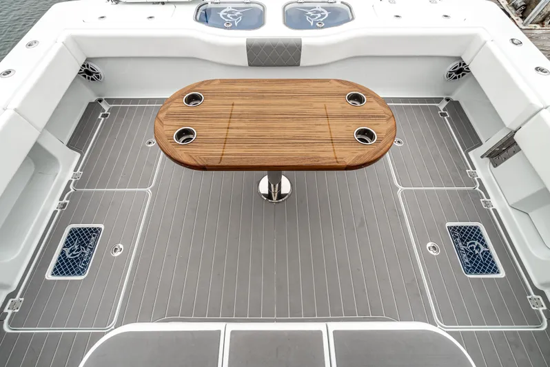  Yacht Photos Pics 2024 Freeman 47 boat deck with wooden table and cup holders.