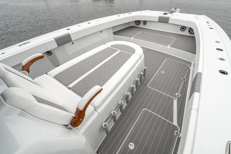  Yacht Photos Pics Luxurious 2024 Freeman 47 boat interior with sleek seating and modern design on calm water.