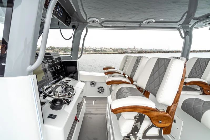  Yacht Photos Pics 2024 Freeman 47 boat interior with modern helm, luxurious seating, and ocean view.