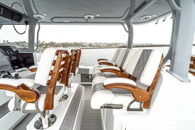  Yacht Photos Pics Luxury seating on 2024 Freeman 47 boat with wood accents and ocean view.