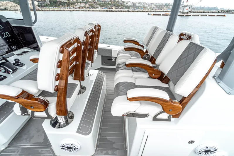  Yacht Photos Pics Luxurious seating on 2024 Freeman 47 boat, featuring elegant wood accents and waterfront view.