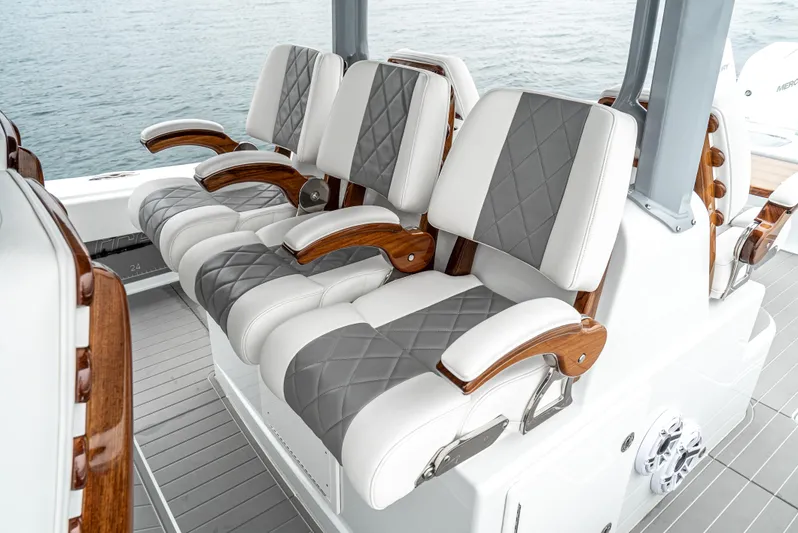  Yacht Photos Pics Luxurious seating on 2024 Freeman 47 boat with elegant wood accents and quilted upholstery.