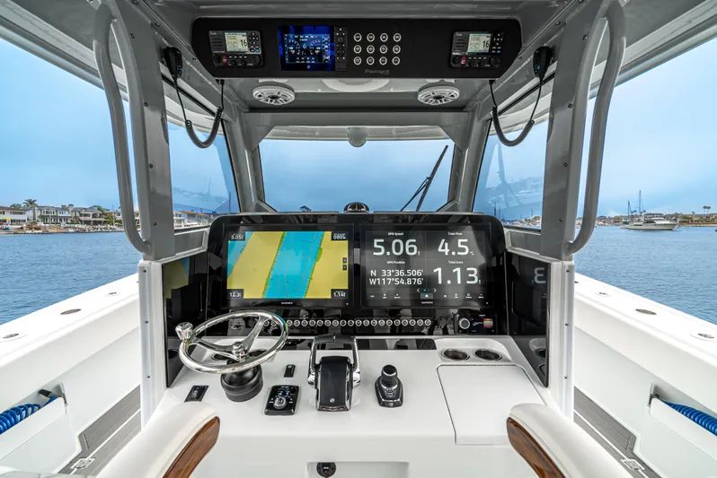  Yacht Photos Pics 2024 Freeman 47 boat cockpit with advanced navigation and control systems, overlooking a marina.